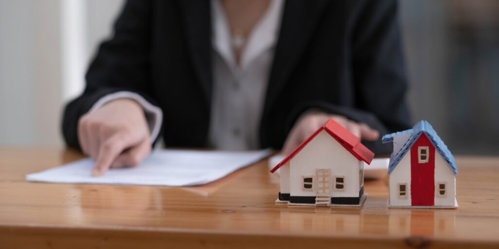 Businesswoman present contact of house insurance contract to purchase a home with a real estate