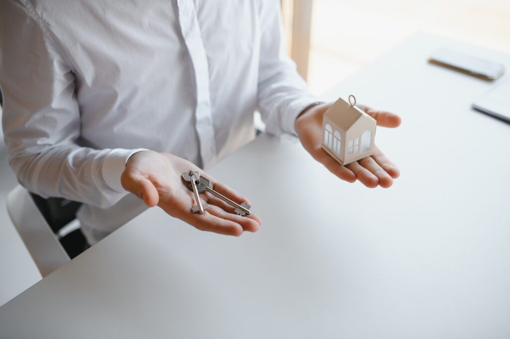 Real estate agent with house model and keys